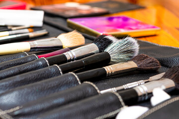 Fototapeta premium Variety of Makeup Tools and Oroducts Neatly Arranged As Organized Display of Colors Including Brushes And Essentials