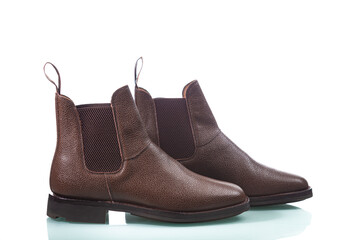 Fashion Footwear ideas. Closeup of Pair of Classic Shagreen Leather Chealsea Boots As Still Life Concepts Placed In Line Over Pure White