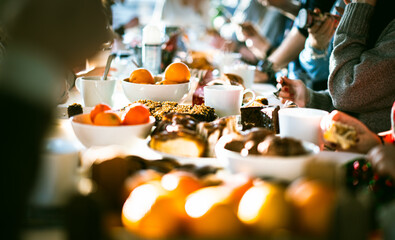 celebrating company event table food orange fruits sweet cakes family office party