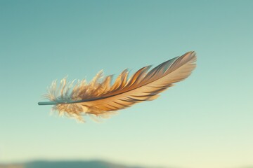 Single light brown feather floats gently against a clear blue sky.