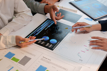 Group of business people brainstorming in analytical plan meeting Calculate the numbers obtained from the graph. Financial growth chart. Marketing. Concept of business success statistics.