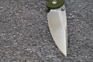 Folding penknife on a grey background close-up