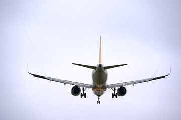 Rear view of passenger airplane landing at Swiss Airport Zürich Kloten on a cloudy autumn day. Photo taken November 30th, 2024, Zurich, Switzerland.