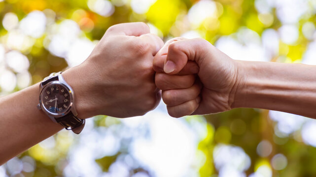 Deal of teamwork with the Man hand a fist bump commit as get together in the office