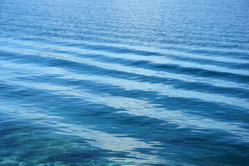 Small waves gently roll over the blue sea