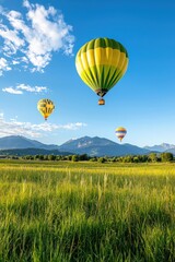 Obraz premium Colorful Hot Air Balloons Over Scenic Mountain Landscape