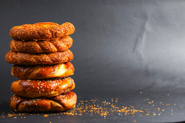 Freshly baked bread rolls stacked against a dark background