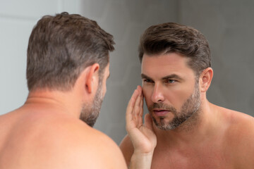 Mens beauty. Cream treatment for mens face. Beauty routine. Face of a beauty man with perfect skin. Anti-aging and wrinkle cream. Concept of male beauty. Male skincare cosmetics concept. Skin care.