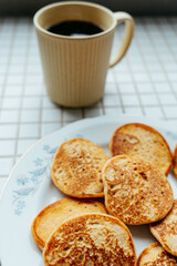 coffee and pancakes on plate on kitchen table, breakfast on sunny morning. healthy eating, vegetarian. top view of food. a nutritious lunch, delicious and balanced.