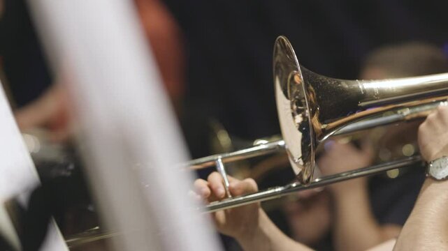 A trombone player playing a section solo during a classical youth symphony orchestra rehearsal. Nr.2