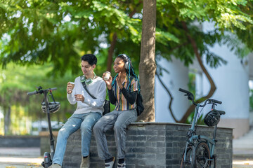 Young Adults Relaxing with Eco Transportation.