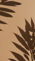 Fototapeta premium Soft shadows of green leaves cast on warm beige wall, creating calming, natural ambiance perfect for interior design or wellness themes.