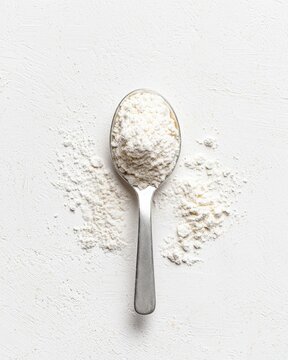 Enhancing wellness with food supplement l-glutamine powder on white spoon