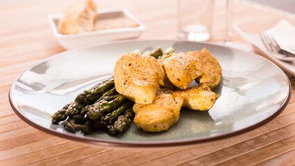 Dietary meal rich in protein. Stir fried chicken breast and green asparagus