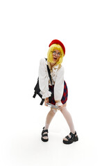 Woman with playful expression, posing in yellow wig, wearing red beret, white blouse, and plaid skirt against white background. Concept of business, occupation, human emotions and facial expressions.