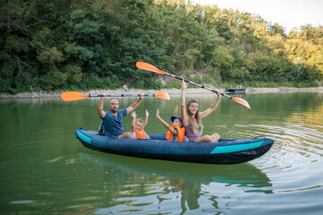 Family enjoying a kayaking trip on a peaceful lake