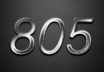 Chrome metal 3D number design of 805 on grey background.