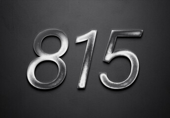 Chrome metal 3D number design of 815 on grey background.