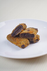 vegetables risoles enclosed in crepe-like wrappers and rolled into bread crumbs and fried. served on wood plate. perfect for recipe, article, catalogue, promotion, or any cooking contents.