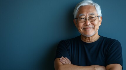 portrait of happy senior Asian man on blue background copy space
