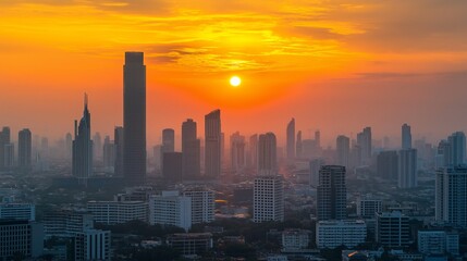 Fototapeta premium Golden light filters through wispy clouds, painting the city skyline in stunning oranges and yellows as the sun descends on a bustling metropolis at dusk, inviting tranquility amidst urban life