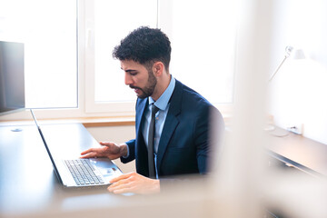 Focused Businessman Working on Laptop in Office