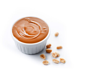 Peanut butter in a bowl isolated on white background. Copy space