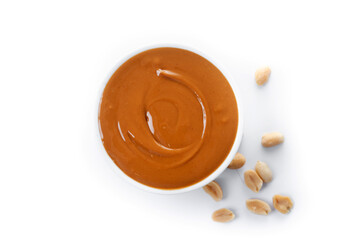 Peanut butter in a bowl isolated on white background. Top view