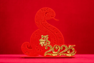 Chinese New Year of Snake mascot on red background translation of the Chinese character is fortune...