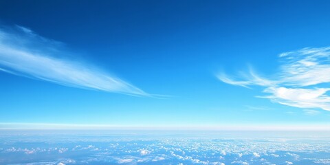 Expansive blue sky stretching across the horizon, captured from a high vantage point in the sky, showcasing the beauty of the blue sky and the serene atmosphere it creates.