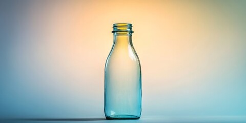 A vacant glass bottle that once contained juice rests against a bright background, highlighting its emptiness and simplicity.