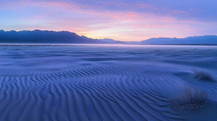 Majestic Desert Sunrise: Purple Hues over Sand Dunes and Mountains