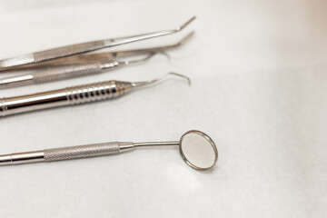 Dentist tools resting on white surface in dental clinic