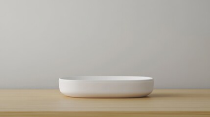 Minimalist Oval White Dish on Wooden Surface with Soft Gray Background, Ideal for Modern Decorative and Table Setting Inspiration