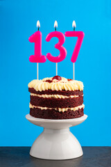 Red velvet birthday cake with number 137 candle
