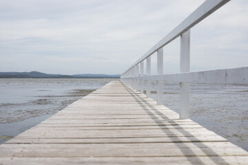 Obraz premium calm lake water pontoon jetty pontoon long sail row