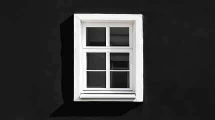 white window on black house facade