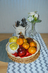 Close-up of a fruit basket showcasing rich textures and colors of fresh produce, arranged artistically on a polished dining table.