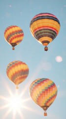 Obraz premium Hot air balloons ascending under a sunburst sky outdoor event colorful experience scenic view adventure in the air
