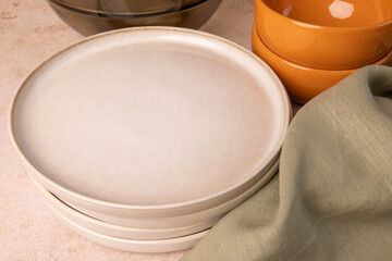 A selection of tableware on a brown stone tabletop.