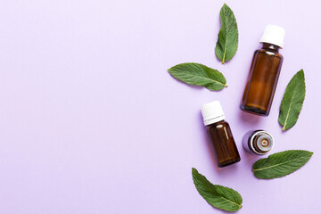 Natural Mint Essential Oil in a Glass Bottle. organic cosmetics with herbal extracts of mint on...