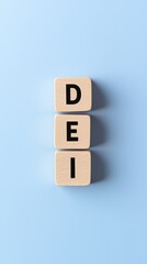 Wooden blocks spelling "DEI" against a minimal light blue background, symbolizing diversity, equity, and inclusion.