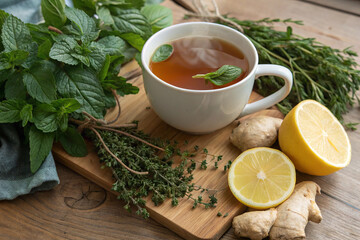 Lemon and ginger tea surrounded by fresh herbs copy