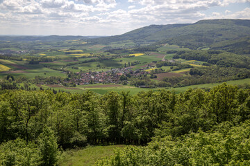 Mountain landscape in Germany near Bad-Sooden-Allendorf in the background on a beautiful sunny day with blue sky and clouds in springtime. High quality photo