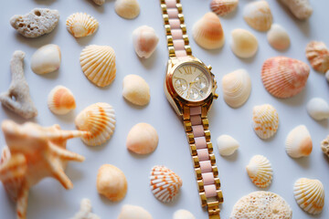 set of seashells with gold color hand watch. new concept image