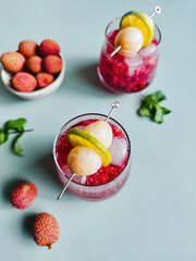 Refreshing lychee drink with raspberry, lime, mint leaves and ice. Non-alcoholic sparkling cocktail fizzy drink perfect for summer hydration.