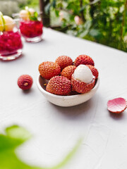 Refreshing lychee drink with raspberry, lime, mint leaves and ice. Non-alcoholic sparkling cocktail fizzy drink perfect for summer hydration.