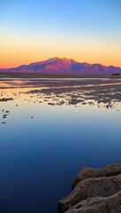 Obraz premium mountain in the distance with a body of water in the foreground