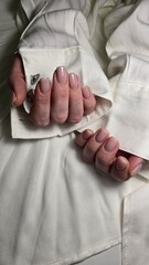 The beauty of the natural nails. Perfect clean manicure. New trendy nail arts on young women hand. Beautiful nail polish in hand