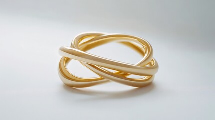 Fototapeta premium Elegant intertwined gold rings on a smooth surface highlighting modern design craftsmanship